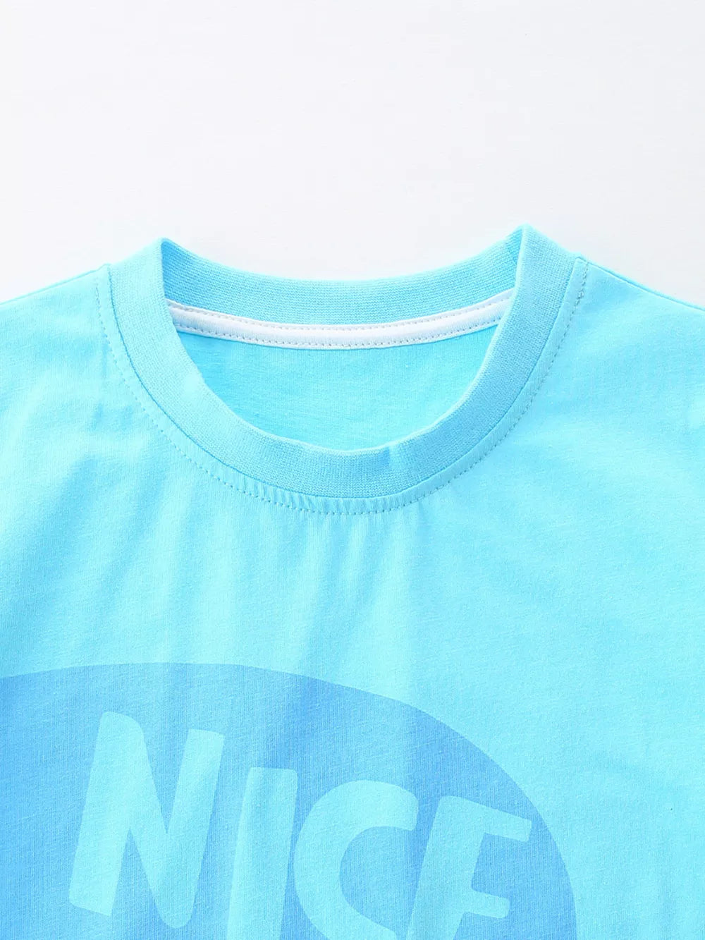Baby blue cotton blend graphic tee with "NICE" text print and crew neck.