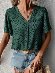 Emerald leopard print v-neck blouse with short flutter sleeves.