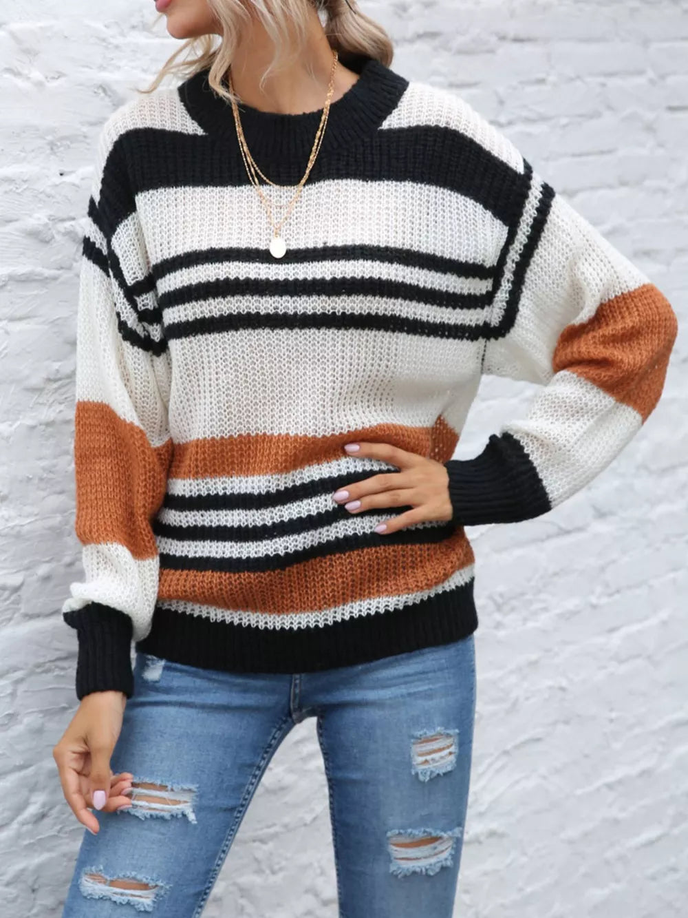 Casual striped knit sweater with color block accents in beige, black, and white acrylic.