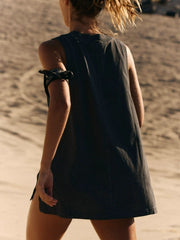 Black wrap-front pocket tank top with side slits and a patterned bandana on the arm.