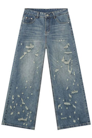Distressed palazzo denim jeans in medium wash with raw edge detail and ripped accents.
