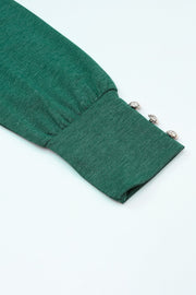 Dark green top sleeve detail with button cuffs