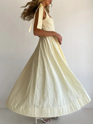 Yellow maxi dress with bow tie shoulder straps and a full skirt