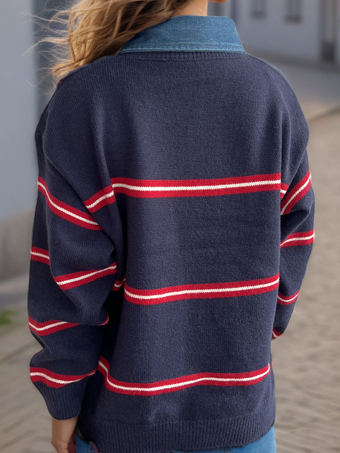 Indigo knit crewneck pullover with red and white nautical stripes and a denim collar.