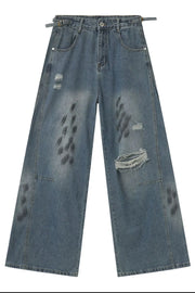 Medium wash relaxed fit denim jeans with distressed details and graphic print.