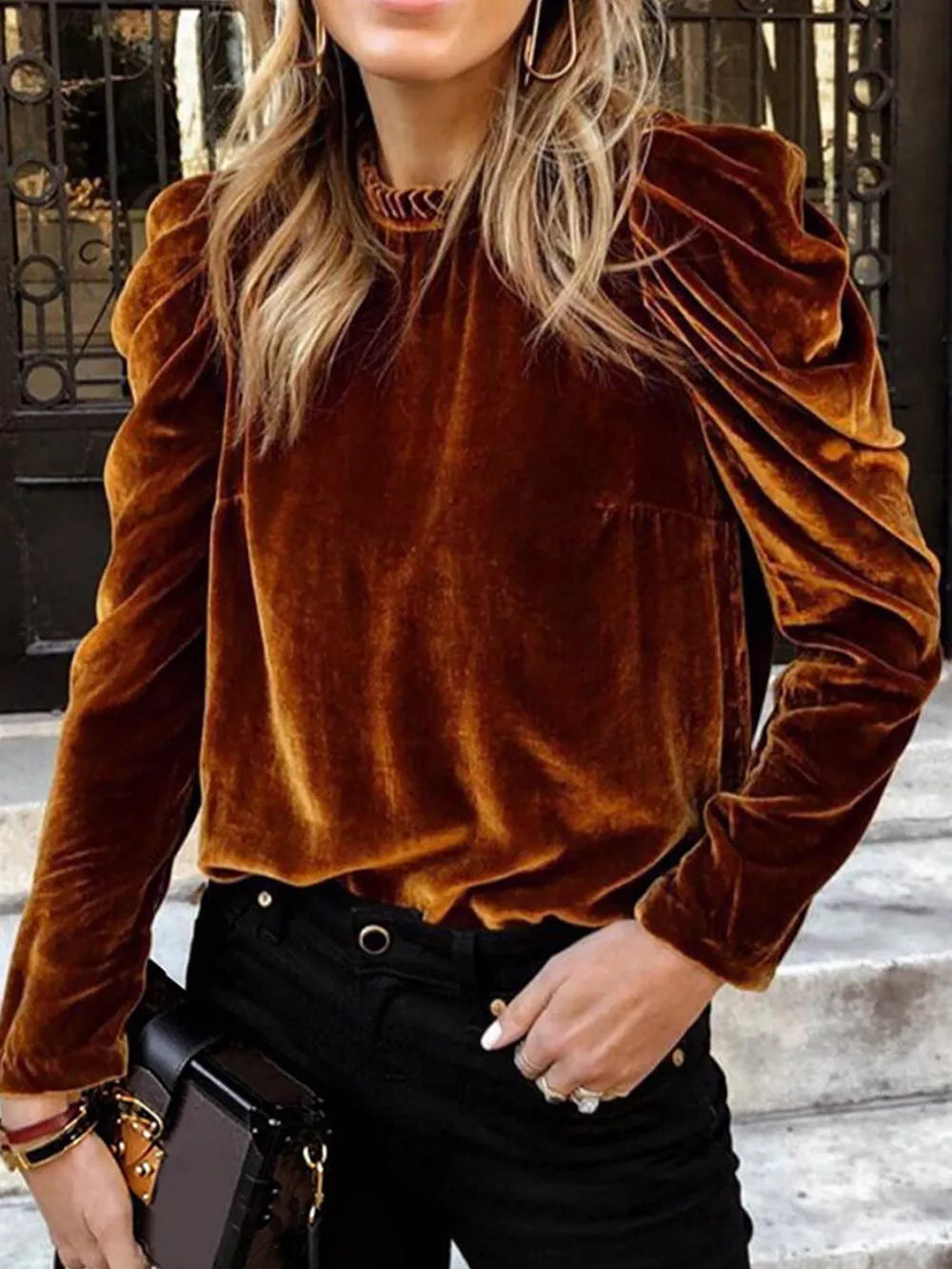 Brown velvet mock neck blouse with ruffled puff sleeves and textured neckline.