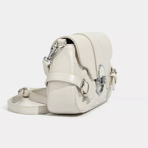 White heart-quilted crossbody bag with buckle accent and silver hardware.