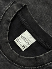 Black acid wash oversized tee with distressed neckline and size XL tag.