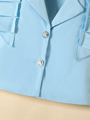 Blue collared toddler outfit with decorative buttons and ruffled trim.