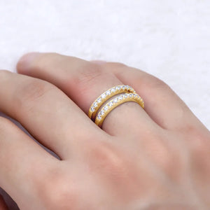 Gold double band ring with pavé set stones on a hand
