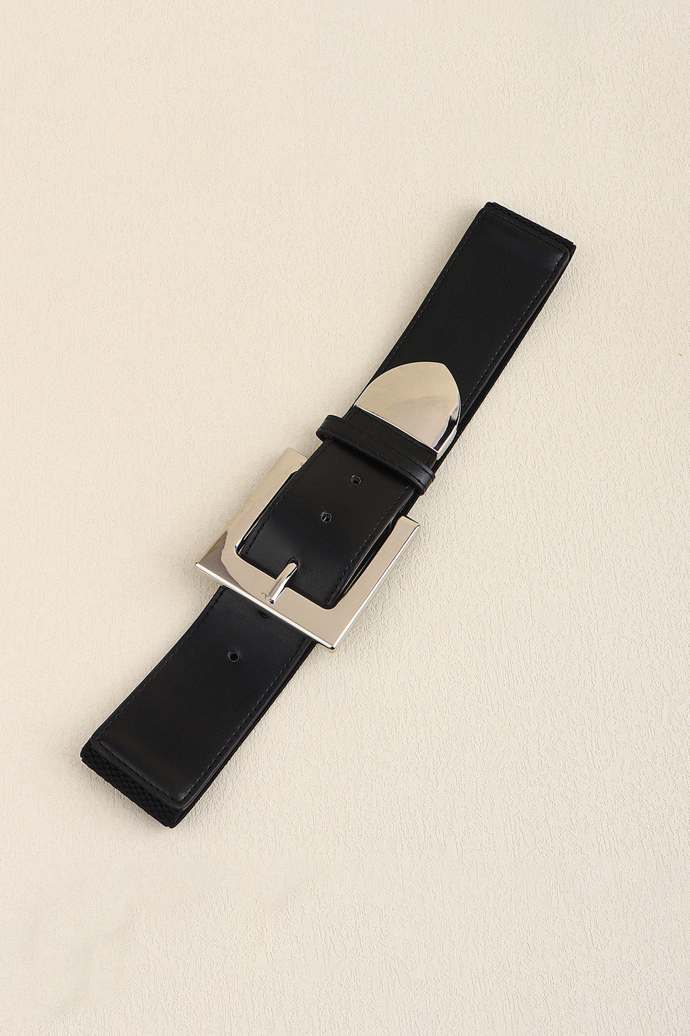 Black faux leather belt with a bold silver buckle and polished metal accents.