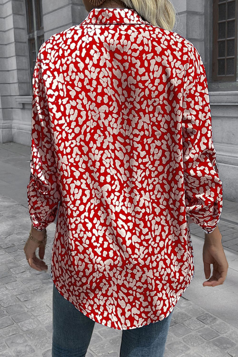 Women's oversized shirt in deep red with abstract spot print, buttoned front, and long sleeves.