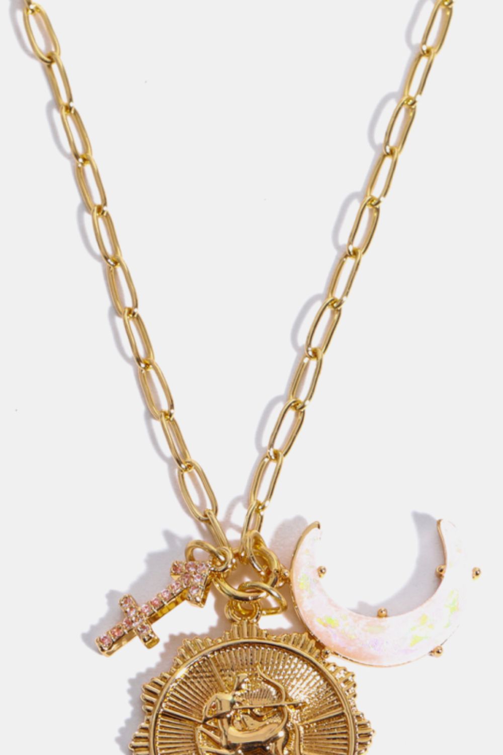 Gold chain pendant necklace with Sagittarius zodiac sign, moon, and cross charms.