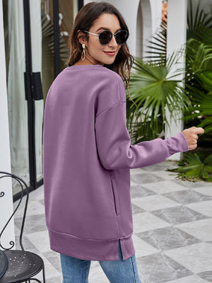 Dusty Purple tunic sweatshirt with crewneck, side pockets, and side slits.