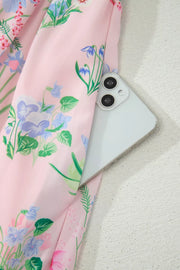 Pink midi dress with a wildflower print, showing a phone in the pocket.