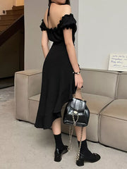 Black asymmetrical ruffle hem off-shoulder dress with halter neck and flowing skirt.