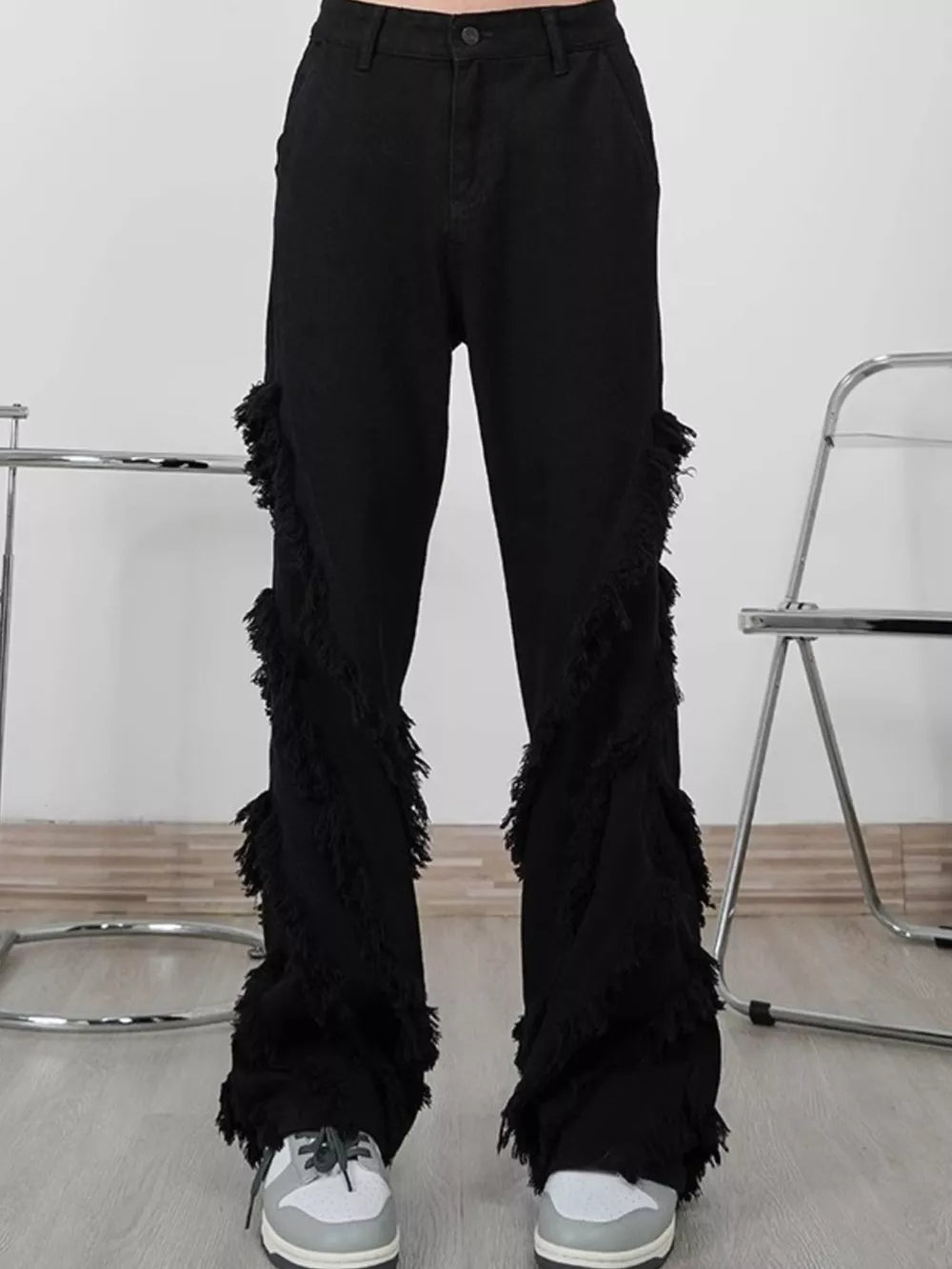 Black wide-leg jeans for men with layered fringe trim detail.