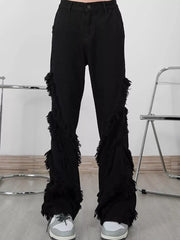 Black wide-leg jeans for men with layered fringe trim detail.