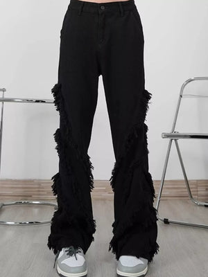 Black wide-leg jeans for men with layered fringe trim detail.