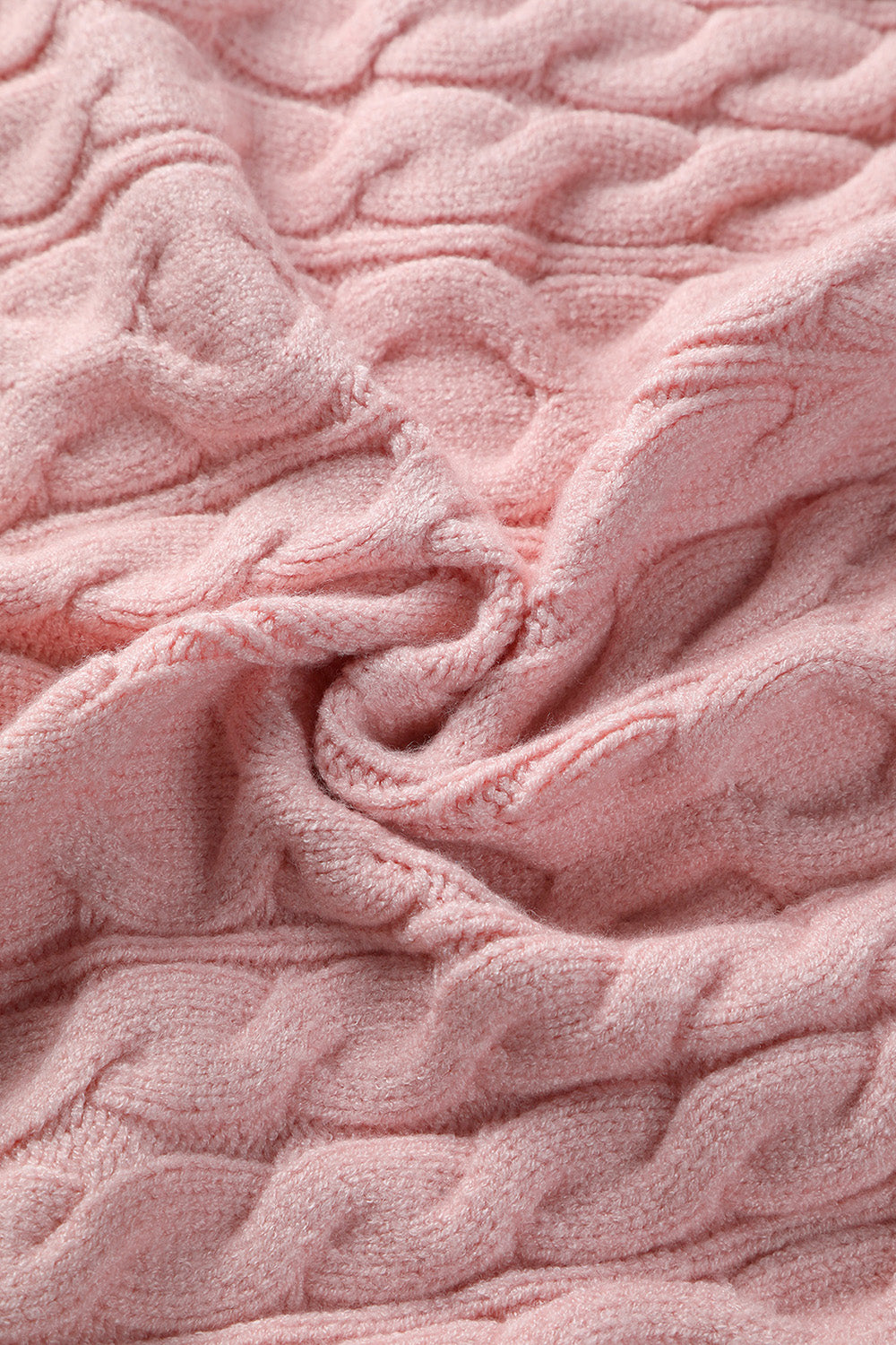Blush pink cable knit sweater with a textured weave.