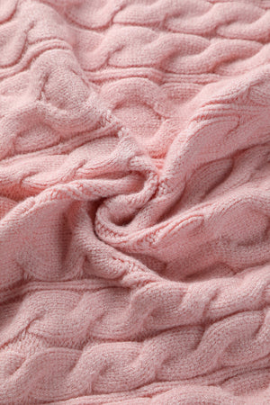 Blush pink cable knit sweater with a textured weave.