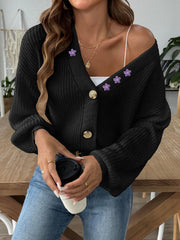 Black balloon sleeve cardigan with floral embellishments and buttons.