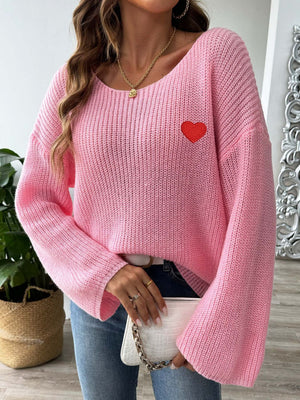 Pink slouchy boatneck knit sweater with embroidered red heart detail.