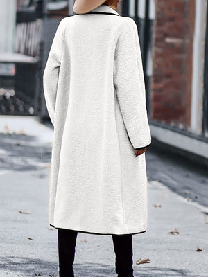 White teddy coat with black contrast trim detailing and a relaxed fit.