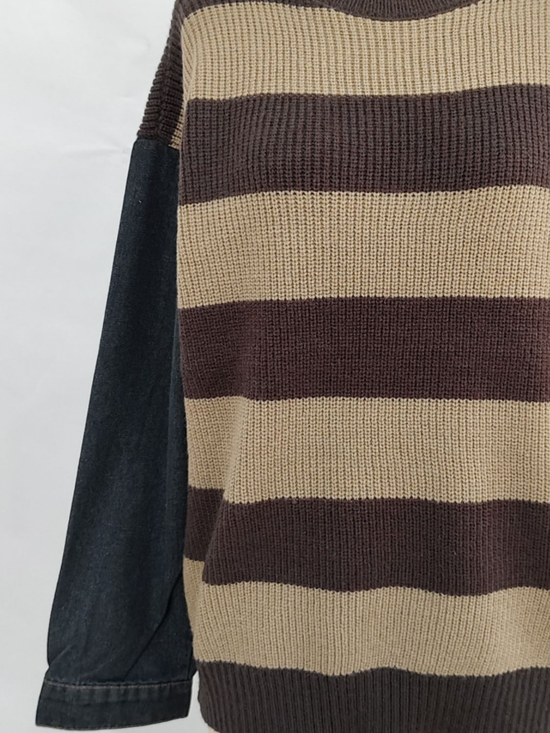 Brown and tan striped knit sweater with black denim sleeves.