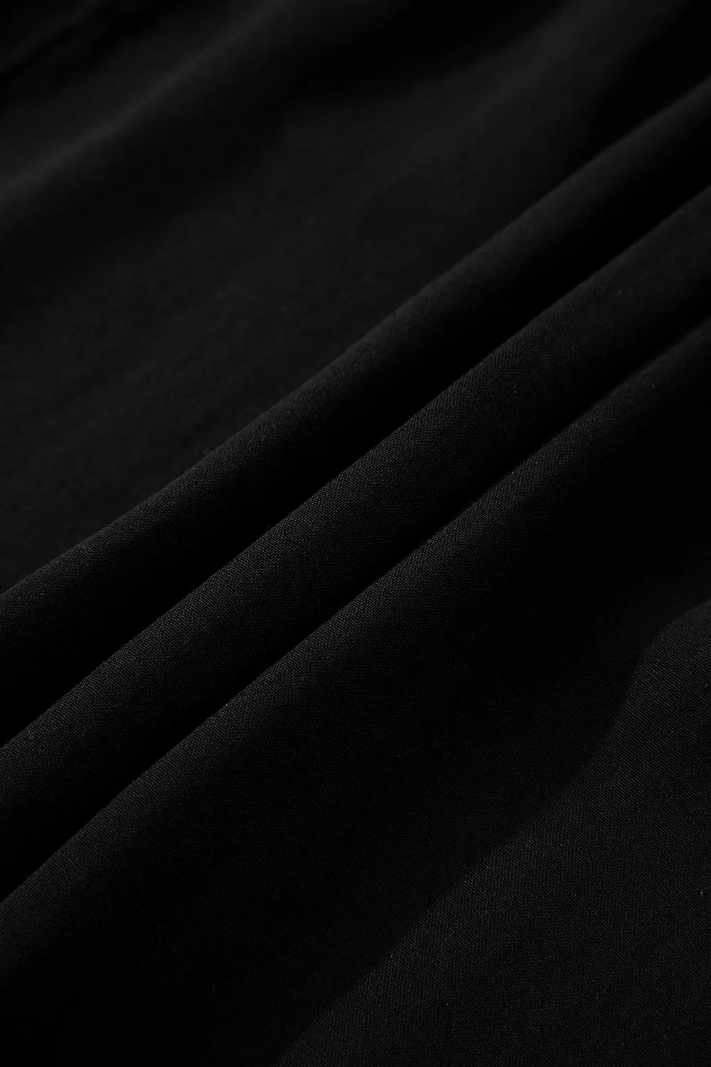 Black tiered maxi dress with hidden placket detail.