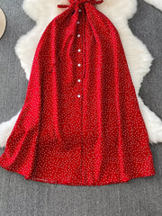 Red polka dot maxi dress with button front and tie neck detail.