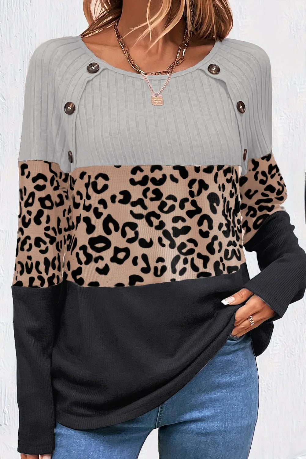 Colorblock leopard ribbed knit top with button detail and gray, tan, and black panels.