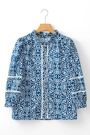 Peacock blue medallion print poet blouse with white lace trim and ruffled neckline.