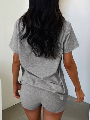 Gray V-neck lounge set with relaxed fit t-shirt and shorts.