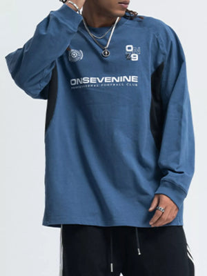 Relaxed fit royal blue long-sleeve tee with contrast side panels and graphic print.