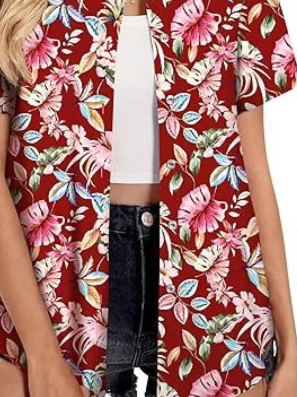 Red tropical hibiscus print button-up shirt with short sleeves, styled open over a white crop top and denim shorts.