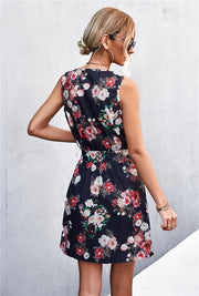 Black floral zip-front mini dress with tie waist and sleeveless design