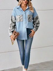 Light wash denim shirt with leopard print pockets and sleeves, button-up style.