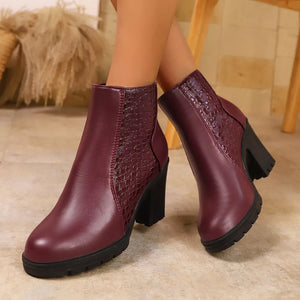 Burgundy crocodile-embossed pointed toe block heel boots with chunky heel.