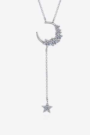 Silver celestial drop necklace with crescent moon and star charms, accented with moissanite.