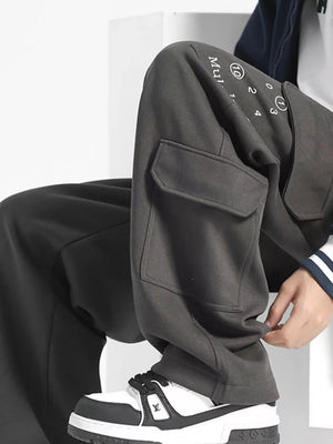 Gray cargo sweatpants with drawstring waist and graphic print detail on the leg.