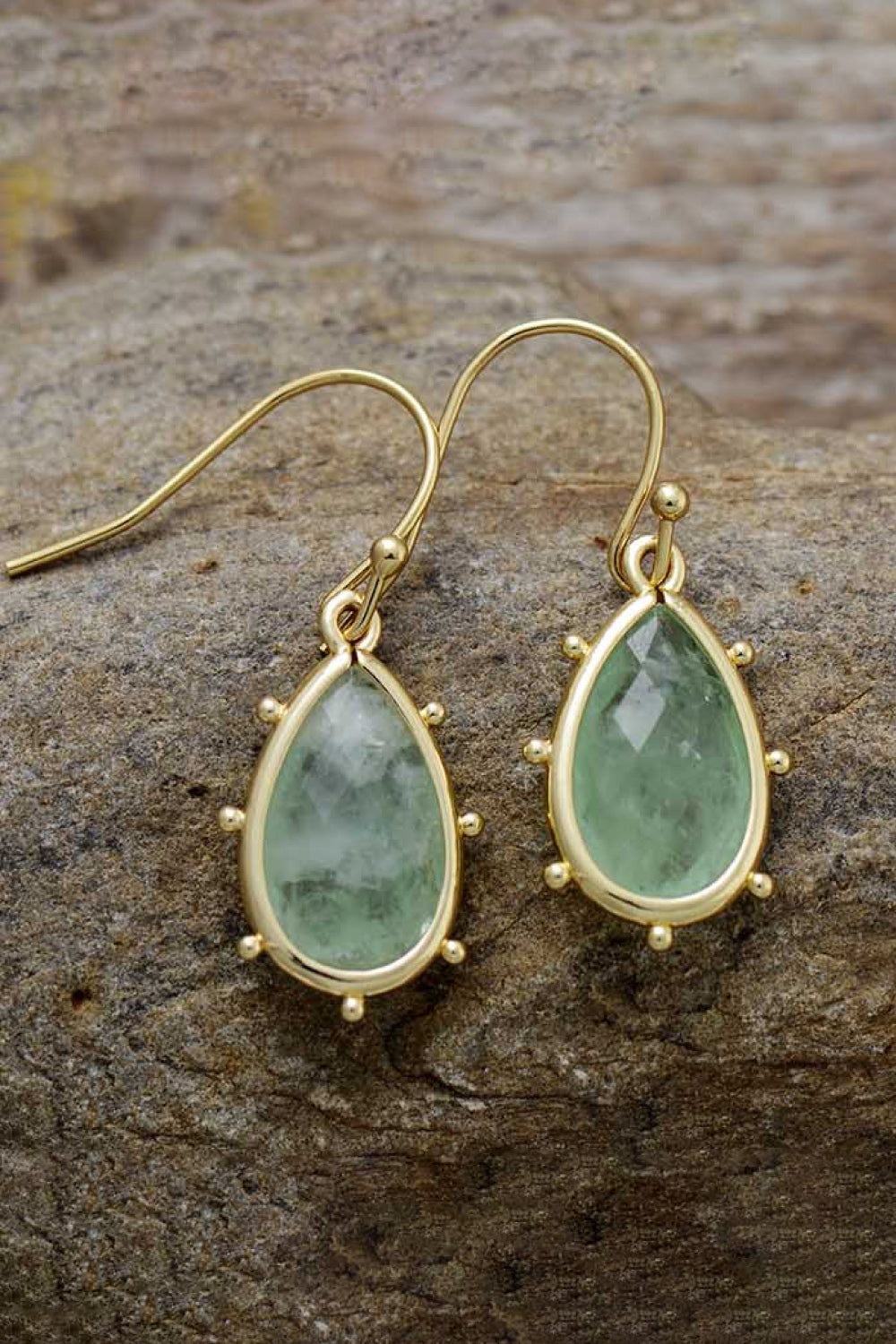 Light green teardrop earrings with gold detailing and beaded accents.