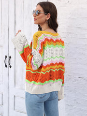 Crochet sweater with rainbow wave pattern, open knit sleeves, and crew neck.
