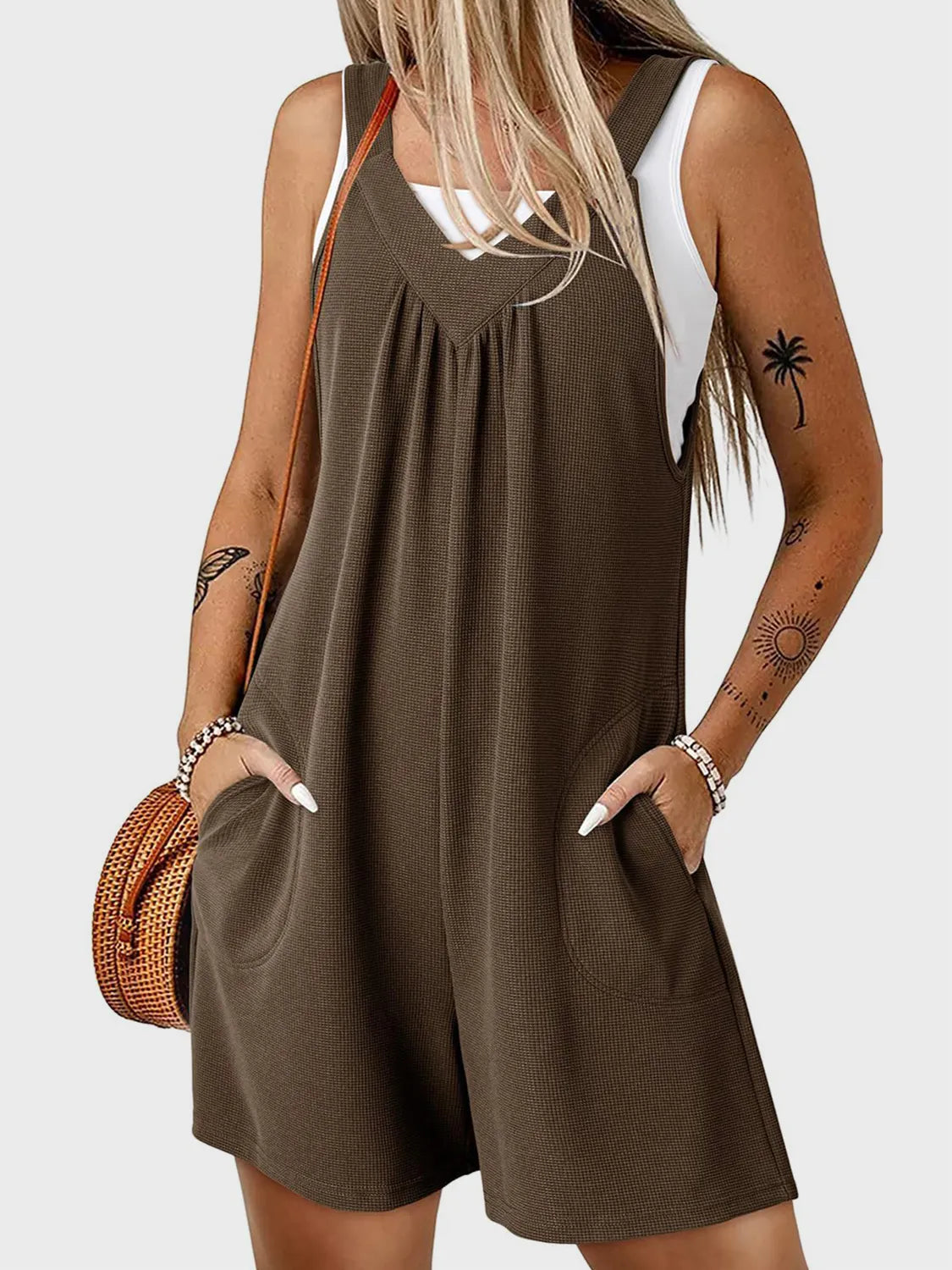 Textured coffee brown romper with gathered yoke, V-neck, and pockets.
