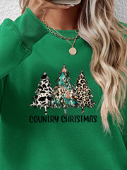 Green sweatshirt with country Christmas trees graphic and text.