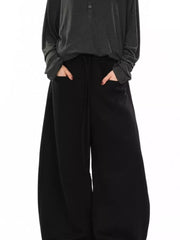 Black wide-leg sweatpants with drawstring and pockets.