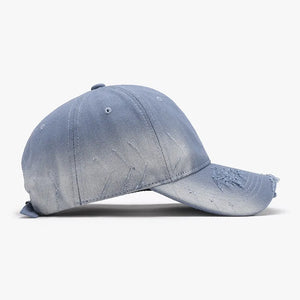 Light blue distressed denim baseball cap with frayed brim and subtle rips.