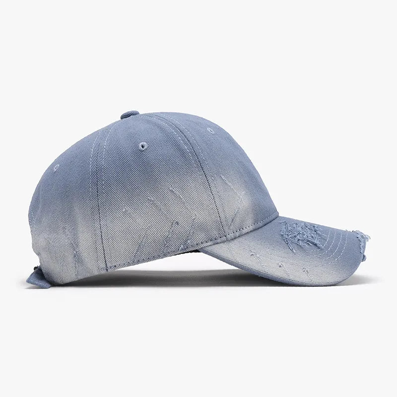 Light blue distressed denim baseball cap with frayed brim and subtle rips.