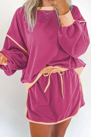Contrast trim sweatshirt and skort set in Red-Violet with peach trim and drawstring waist.