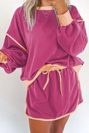 Contrast trim sweatshirt and skort set in Red-Violet with peach trim and drawstring waist.